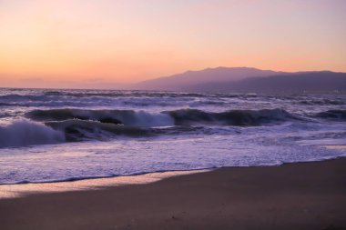 Plaj dalgaları alacakaranlık mor ışık arka planda