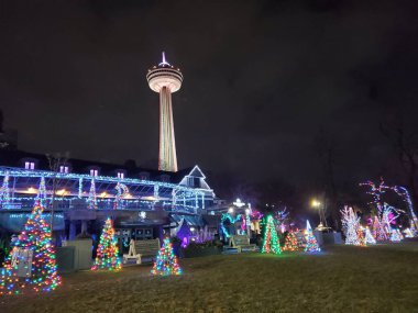 The Niagara Hotel is waiting for the arrival of guests for the Christmas holidays.There are small elegant Christmas trees in front of the hotel and the famous tower rises behind clipart