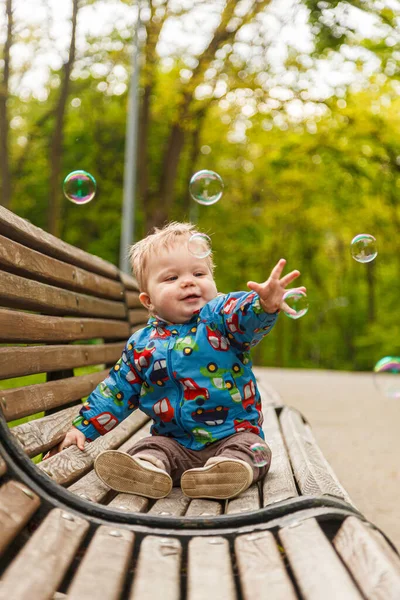 Portrait Little Boy Park Bench Catching Soap Bubbles Close — Photo