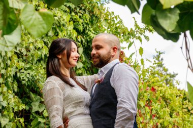 Çiçekli yakışıklı adam nişanlısını öpüyor.