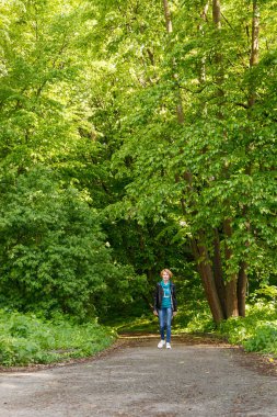 beautiful girl walking in summer park close-up
