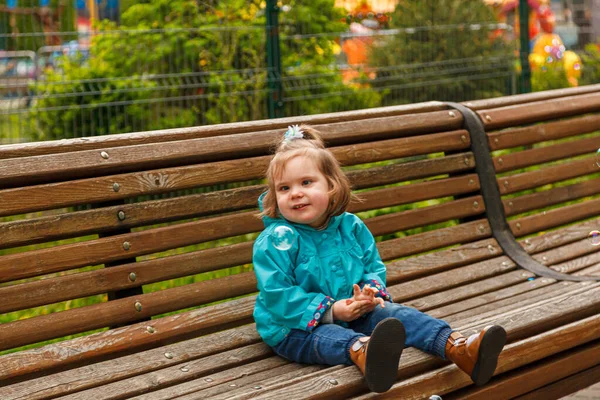 Portrait Little Girl Park Bench Catches Soap Bubbles Close — Stock Photo, Image