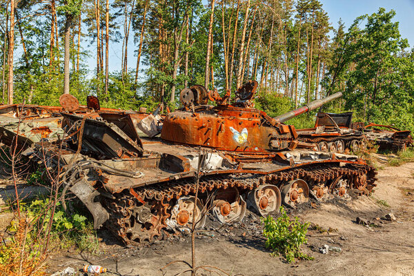 MAKARIV, UKRAINE - June 11, 2022: Broken military military equipment, vehicles, burnt tanks of Russian invaders in the Kyiv region close-up