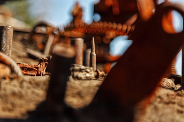 live cartridge on broken military equipment, military operations, Ukraine close-up