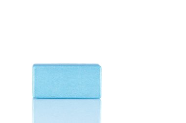 Wooden cube of blue color on a white background close-up