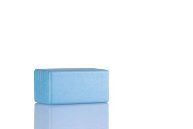 Wooden cube of blue color on a white background close-up