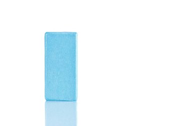 Wooden cube of blue color on a white background close-up