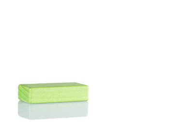 Wooden cube of green color on a white background close up