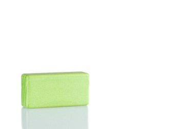 Wooden cube of green color on a white background close up