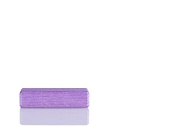 Wooden cube of purple color on a white background close up