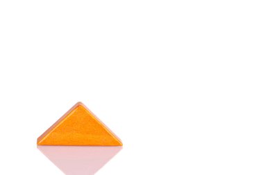 Wooden triangle orange colors on a white background close-up