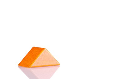 Wooden triangle orange colors on a white background close-up