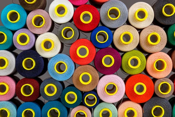 set of multi-colored spools of thread for sewing close-up