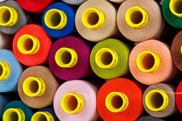 set of multi-colored spools of thread for sewing close-up