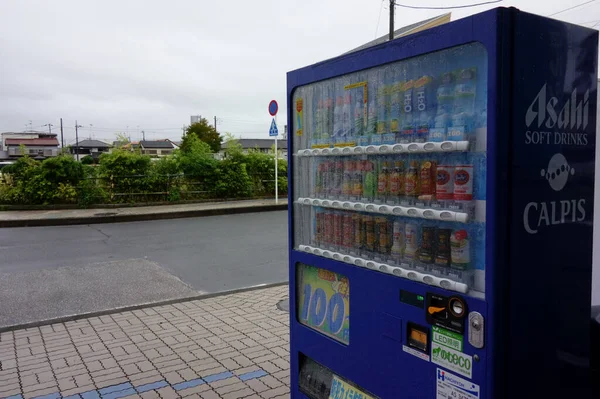 A vending machine for cans covered with raindrops on a rainy day