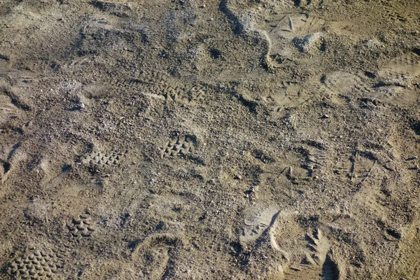 Texture pattern of sand with traces of dirt and dirt