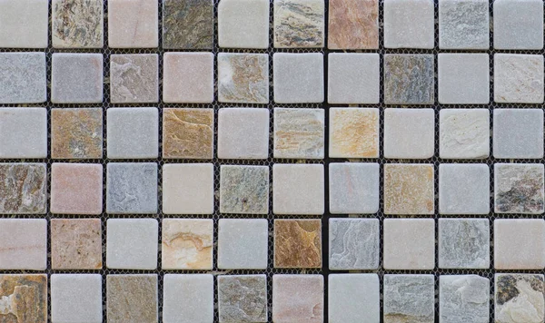 Abstract, geometric, tiled pattern of solid stone