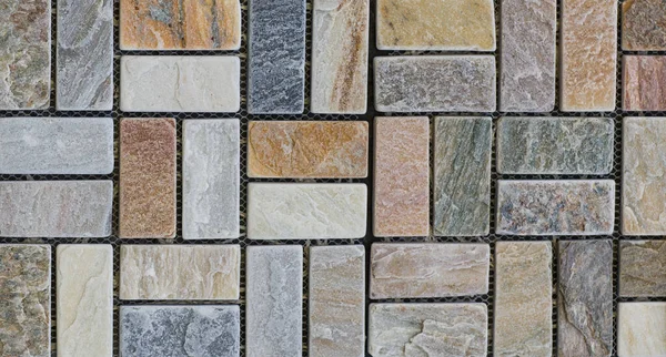 Abstract, geometric, tiled pattern of solid stone