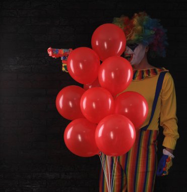 Kırmızı balonlu kötü palyaço.