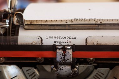 Almanca kelime testi sonucu negatif. Beyaz bir sayfa üzerinde siyah-kırmızı kurdeleli eski bir mekanik daktilo ile yazılmış.