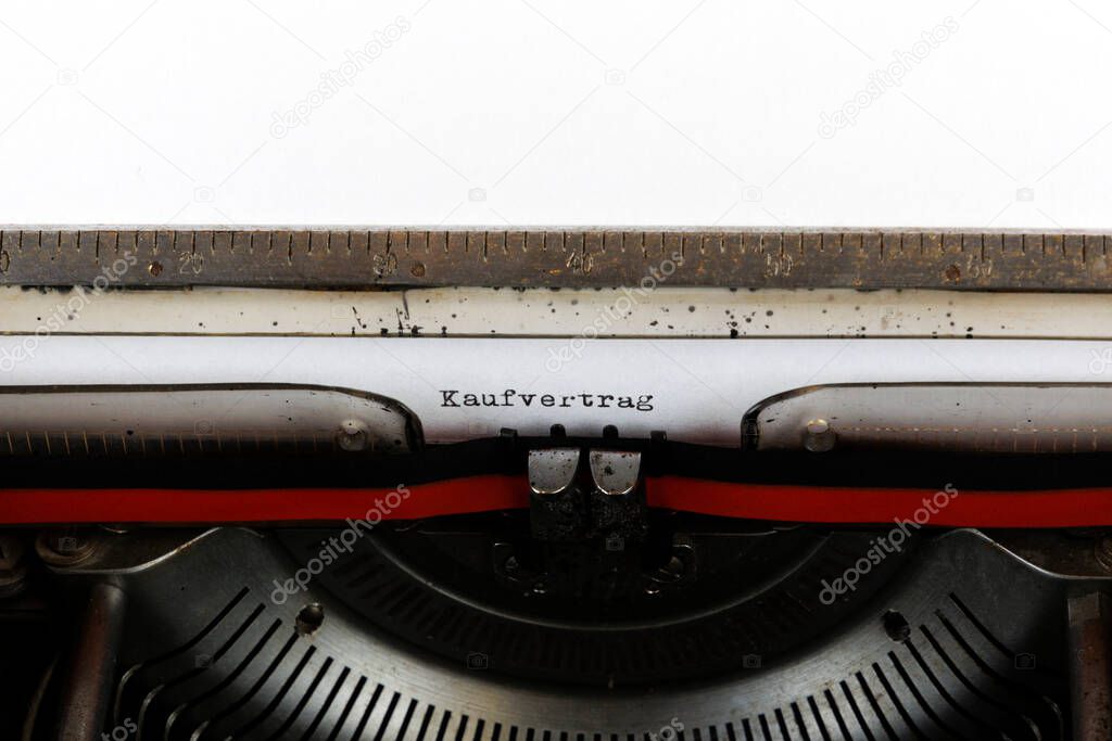 The German word Kaufvertrag written on an old mechanical typewriter German Text: Purchase contract