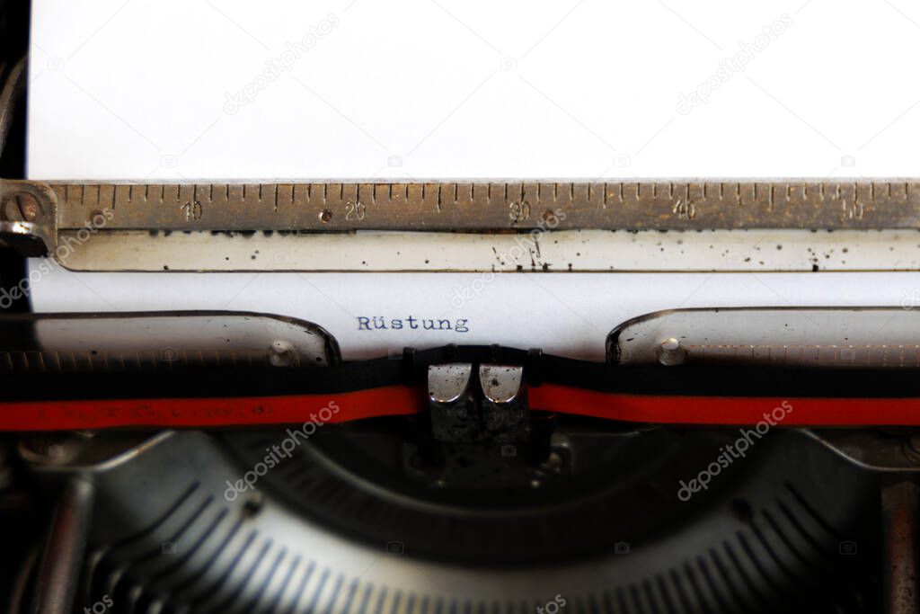 The German word Humanitre Hilfe written in red on an old mechanical typewriter 