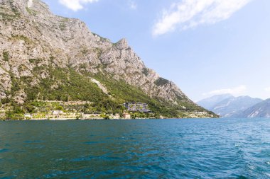 Wooded mountain top and rock wall on the northern shore of Lake Garda in Italy