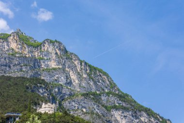 Wooded mountain top and rock wall on the northern shore of Lake Garda in Italy