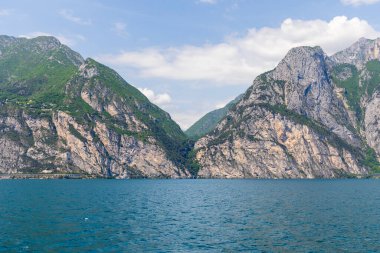 Wooded mountain top and rock wall on the northern shore of Lake Garda in Italy