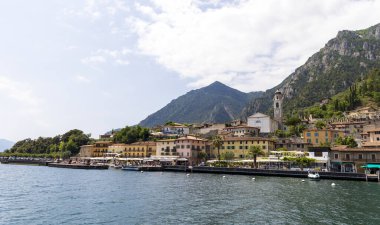 Italy, Limone sul Garda, 2022-05-19, View from a ship on the lake side of the town of Limone on Lake Garda in Italy