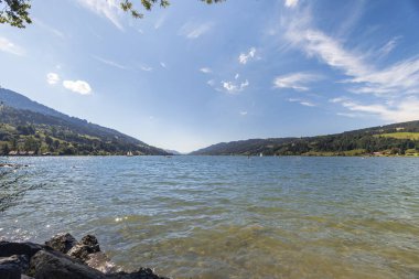 View over the Alpsee near Immenstadt to the opposite shore with mountains and forests