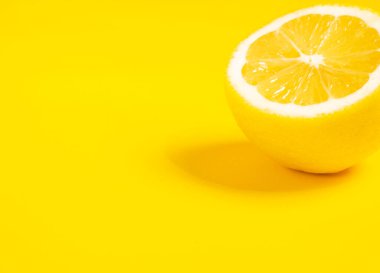 limon meyvesi Sarı arka planda sulu bir dilim limon izole edilmiş.