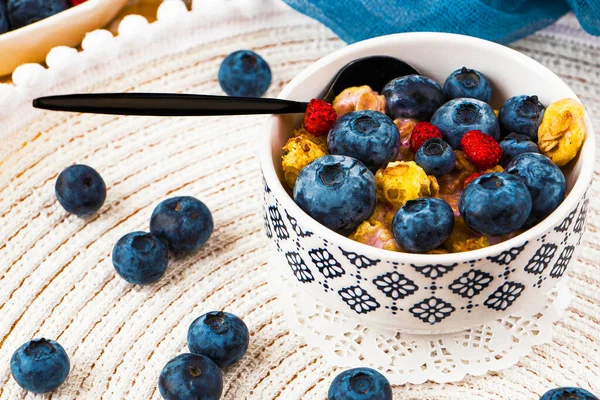 Bowl homemade crispy granola with yogurt, fresh blueberry, berries. healthy cereal morning breakfast. healthy eating, vegan food concept. Colorful breakfast for kids. fitness breakfast. crunches