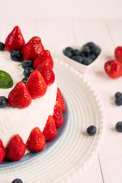 berry dessert. Cake decorated with fresh berries ready to eat. festive berry cake. homemade strawberry cake cut. Strawberry pie decorated with fresh strawberries stands on a plate.