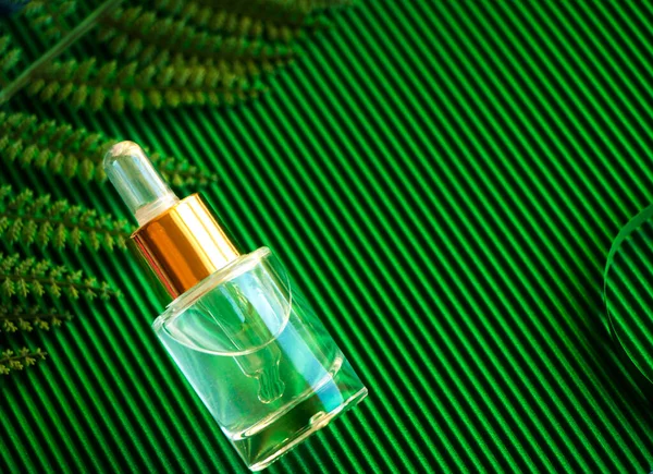 natural Moisturizing Face Serum on a green background close-up. Hyaluronic Acid, hydration skin, drops Bottle. skin care transparent serum liquid dropper minimal.