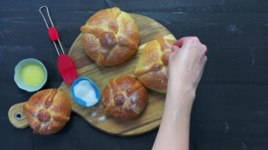 Pan de muerto. Hands baking bread for the Day of the Dead in Mexico. Copy space.