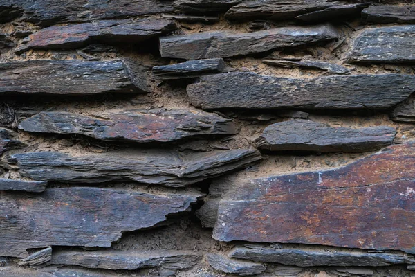 Old slate stone wall texture. Stone background. Copy space.