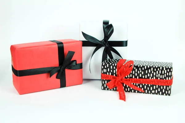 Gifts Wrapped Colorful Paper Red Black Bows White Background — Stock Photo, Image