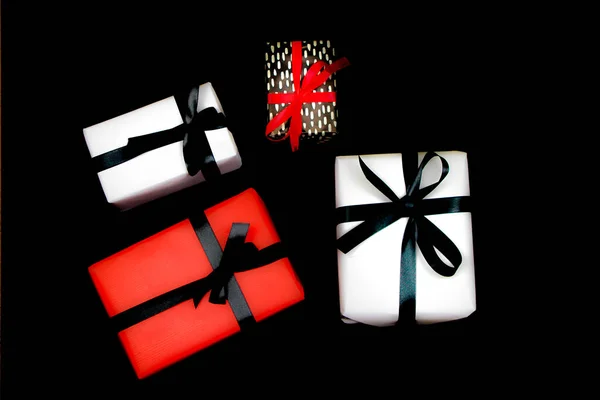 Gifts Wrapped Colorful Paper Red Black Bows Black Background — Stock Photo, Image