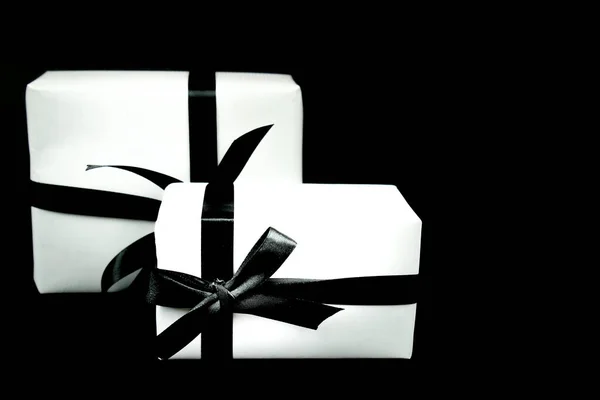 Gifts Wrapped White Paper Black Bows Next Black Background — Stock Photo, Image