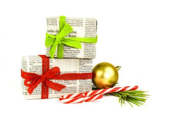 Madrid, İspanya - 17 Aralık 2021: Beyaz arka planda çam dalı, ip ve mücevherlerle eski gazetelere sarılı hediyeler