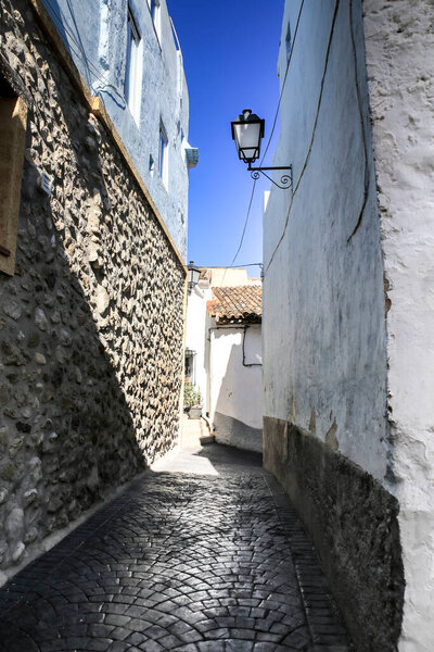 Narrow Street and typical facade of Bolulla village in Alicante, Spain