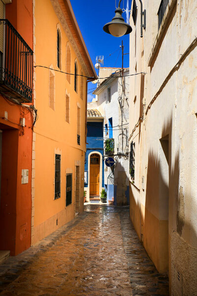 Narrow cobbled street and beautiful facades in Finestrat village, Alicante, Spain