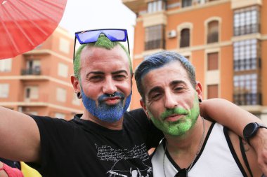 Santa Pola, Alicante, İspanya - 2 Temmuz 2022: İspanya Gay Onur Yürüyüşü 'ne gökkuşağı bayrakları, afişler ve renkli kostümlerle katılıyor
