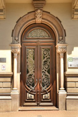 Cartagena, Murcia, Spain- July 18, 2022: Beautiful carved wooden door and golden details of Aguirre Palace in Cartagena