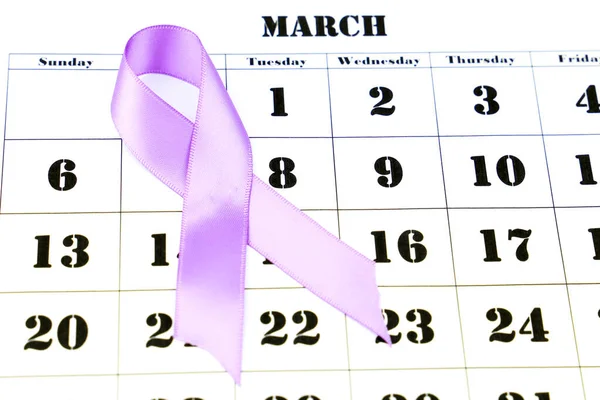 Colorful purple awareness ribbon on march calendar