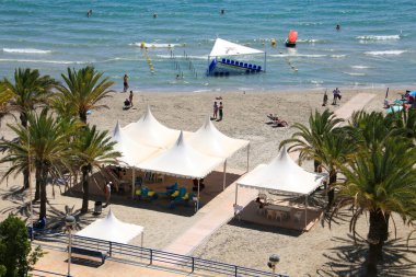 Santa Pola, Alicante, Spain- August 9, 2022 :Levante beach and facilities for disable people on the shore in Santa Pola on a sunny day of summer