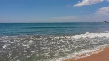 Sandy beach with ocean surf and waves. Sri Lanka. Summer and travel vacation concept.