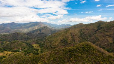 Mountains covered rainforest, trees and blue sky with clouds. Sri Lanka.