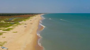 Seascape with tropical sandy beach and blue ocean. Sri Lanka. Thaalayadi Beach. Summer and travel vacation concept.